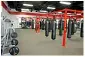 A gym with many red equipment and black bags